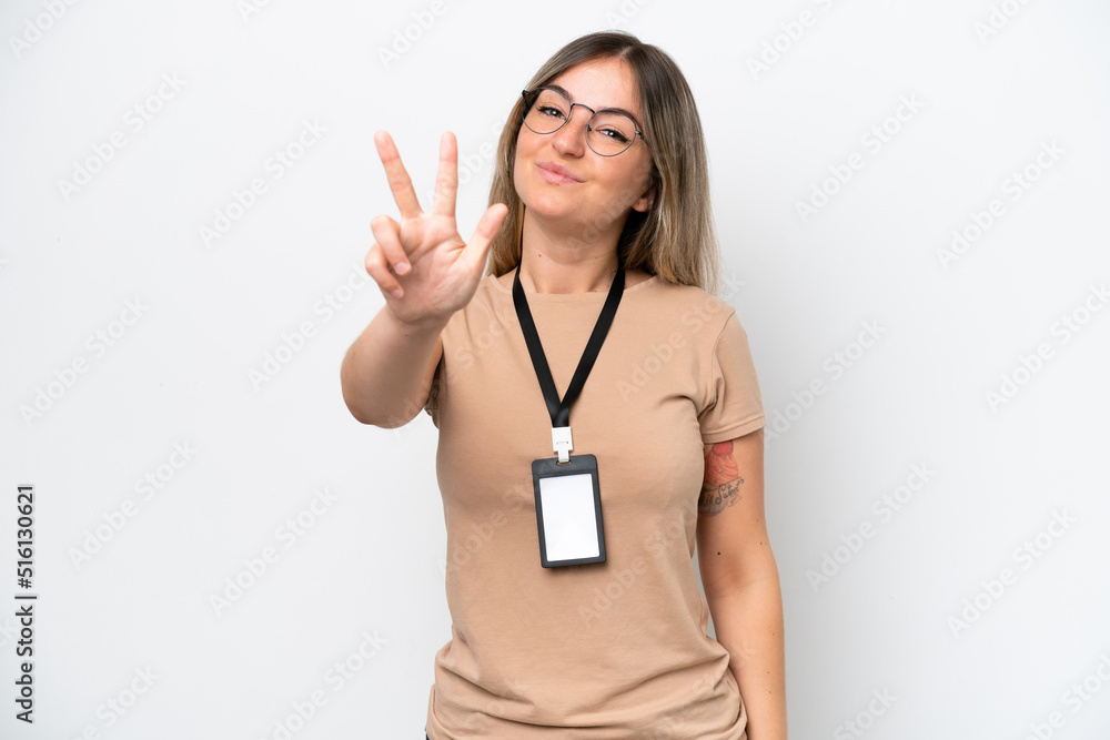 Young Rumanian woman with ID card isolated on white background happy and counting three with fingers Young Rumanian woman with ID card isolated on white background happy and counting three with fingers