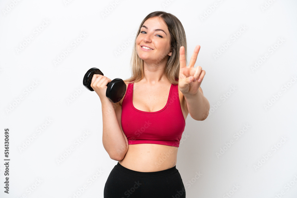 Young sport Rumanian woman making weightlifting isolated on white background smiling and showing victory sign Young sport Rumanian woman making weightlifting isolated on white background smiling and showing victory sign