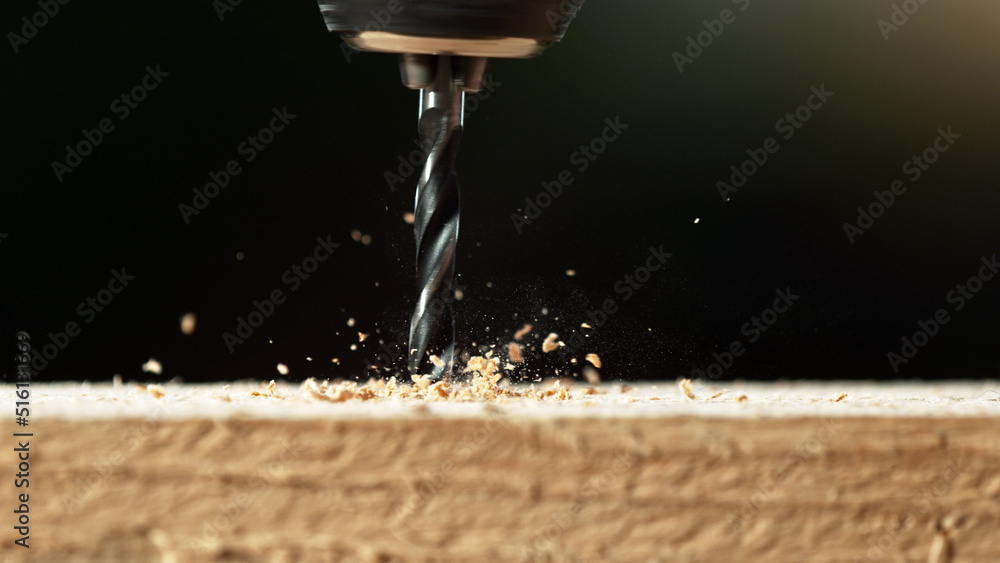 Super macro shot of steel drill with wood chippings flying off. Super macro shot of steel drill with wood chippings flying off.