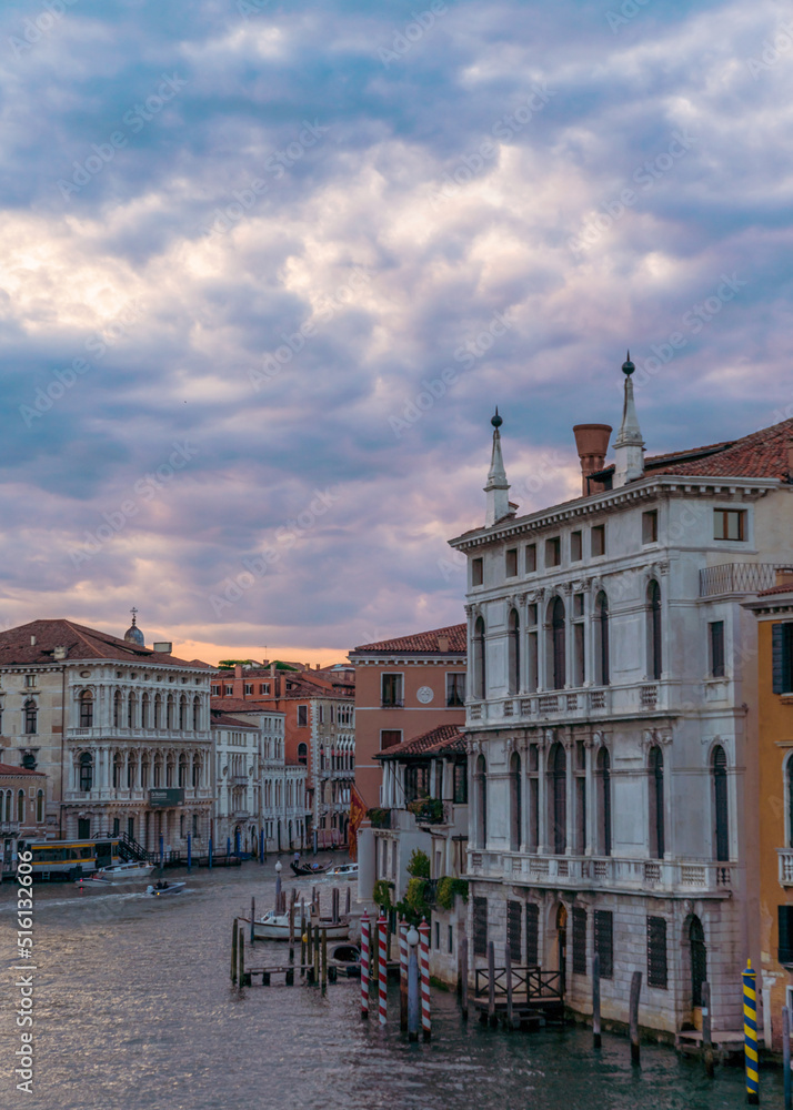 Incredible sunset, clouds and traditional venetian architecture seen from the grand canal in Venice, Italy