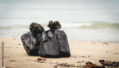 Large bags with collected plastic and other waste on the beach © romaset