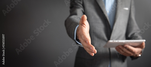 Businessman offering hand for handshake at office.