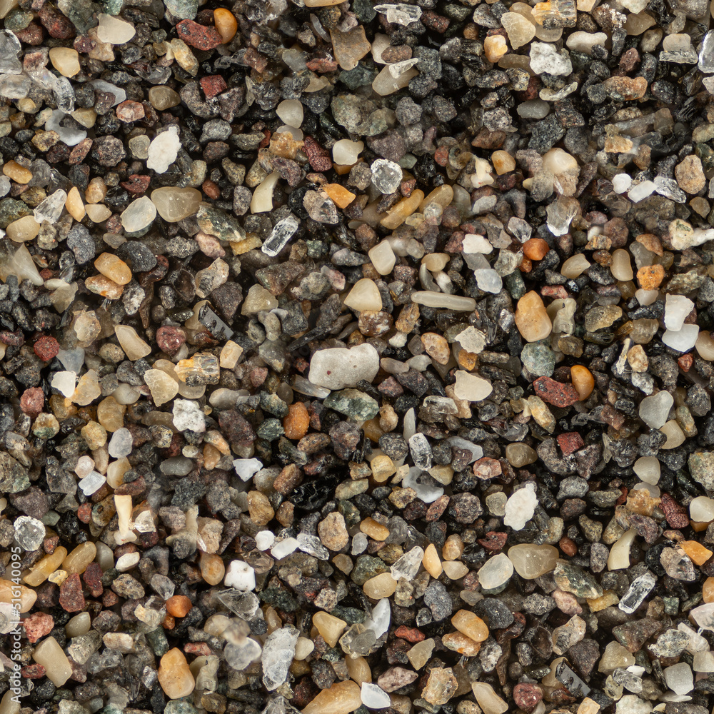 Sea sand with dark volcanic particles, microscope photo made into seamless tileable pattern texture Sea sand with dark volcanic particles, microscope photo made into seamless tileable pattern texture