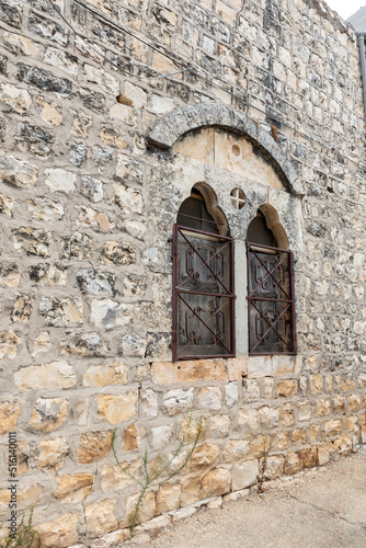 Stone facade of an ancient building in the Arab Christian village Miilya, in the Galilee, in northern Israel © svarshik