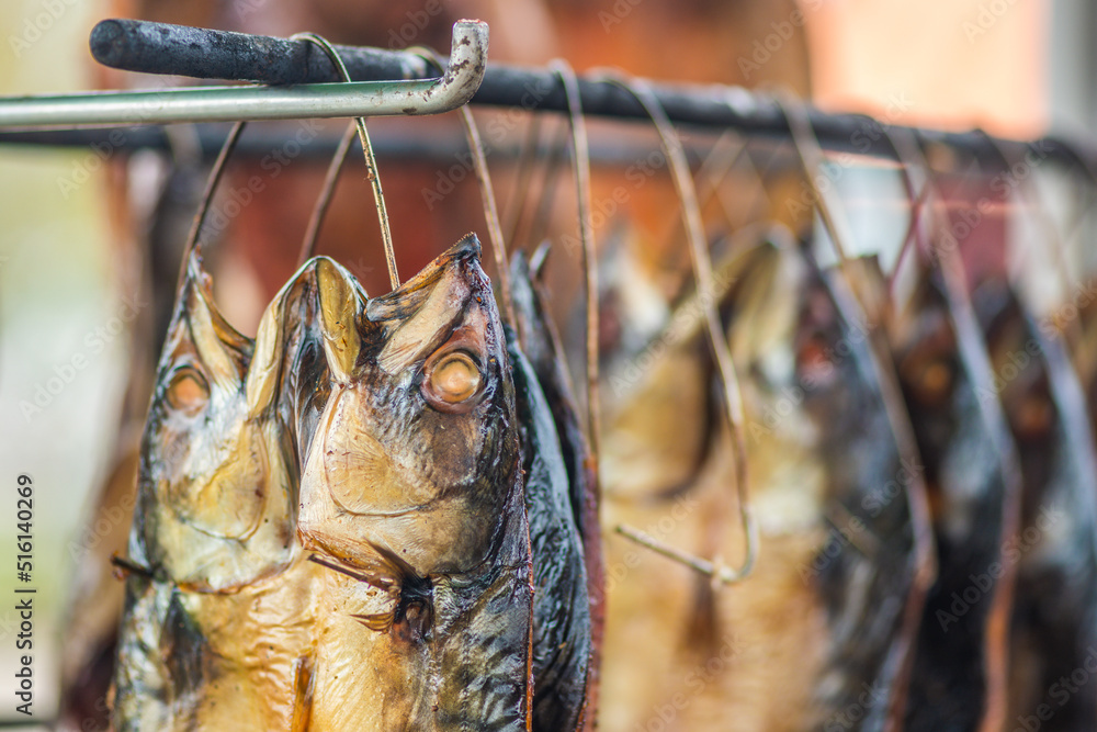 Hanging smokedried mackerel fish in a fish market just smoked with