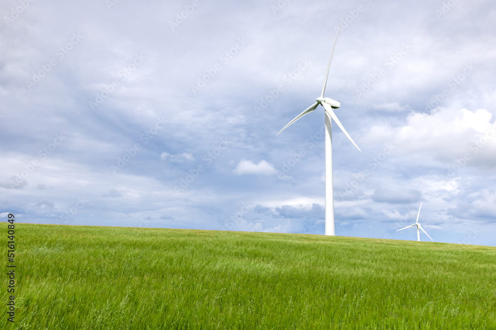 Onshore wind turbine with green grass foreground Onshore wind turbine with green grass foreground