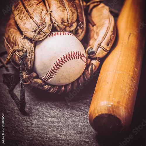old baseball glove with ball and bat