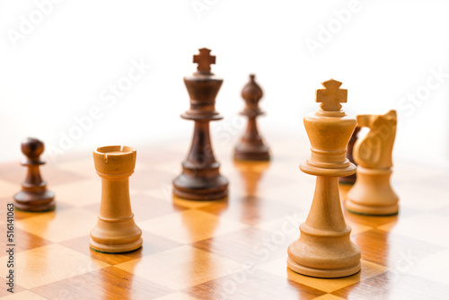 Chess pieces on a chessboard with white background