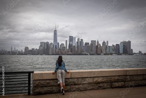 girl looking at the new york skyline on an overcast day