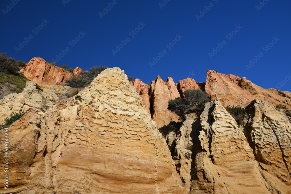 Close view of reddish jagged sandstone formations that make up part of Red Bluff, a natural landmark in metropolitan Melbourne