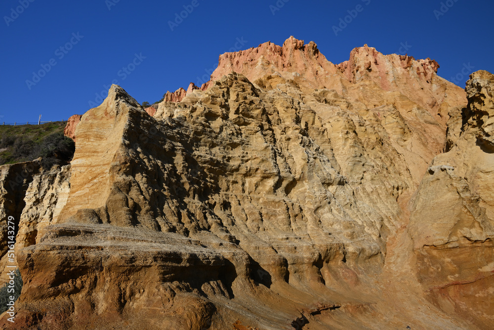 Fototapeta premium Close view of one the segments of Red Bluff, a reddish sandstone landmark in metropolitan Melbourne, that juts out from the main cliff