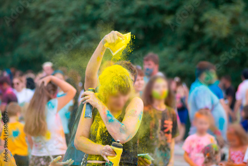 holi holiday! yellow paint on people's heads! multicolored paints are everywhere