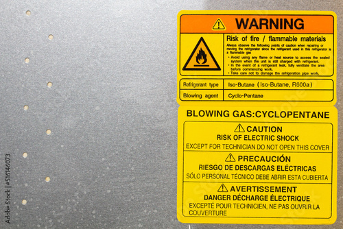 Warning. Blowing gas. Cyclopentane. Blowing agent.  Warning label on household appliances. Refrigerator repair in the workshop. Service maintenance. The back side of equipment. Copy space for text