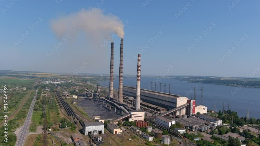 Thermal power plant. Large chp with high pipe 3 cooling towers. Smoke coming from pipes of a working chp. Environmental pollution. Smoke with harmful substances is ejected into air of atmosphere Thermal power plant. Large chp with high pipe 3 cooling towers. Smoke coming from pipes of a working chp. Environmental pollution. Smoke with harmful substances is ejected into air of atmosphere
