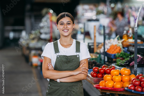 Woman seller at the counter with vegetables. Small business concept photo