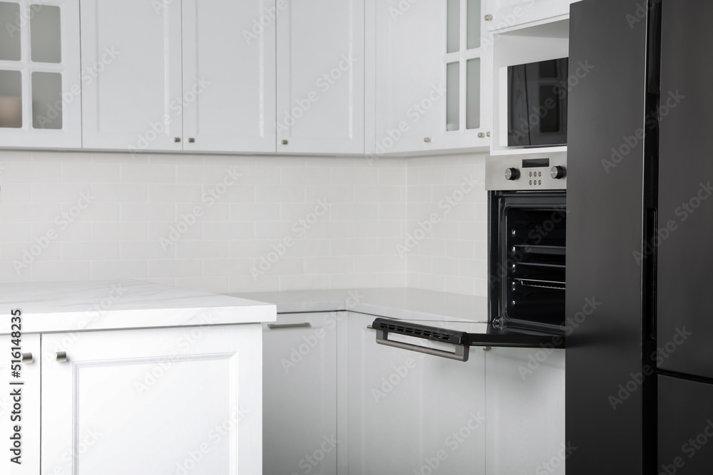 Fototapeta premium Modern oven and microwave in white clean kitchen