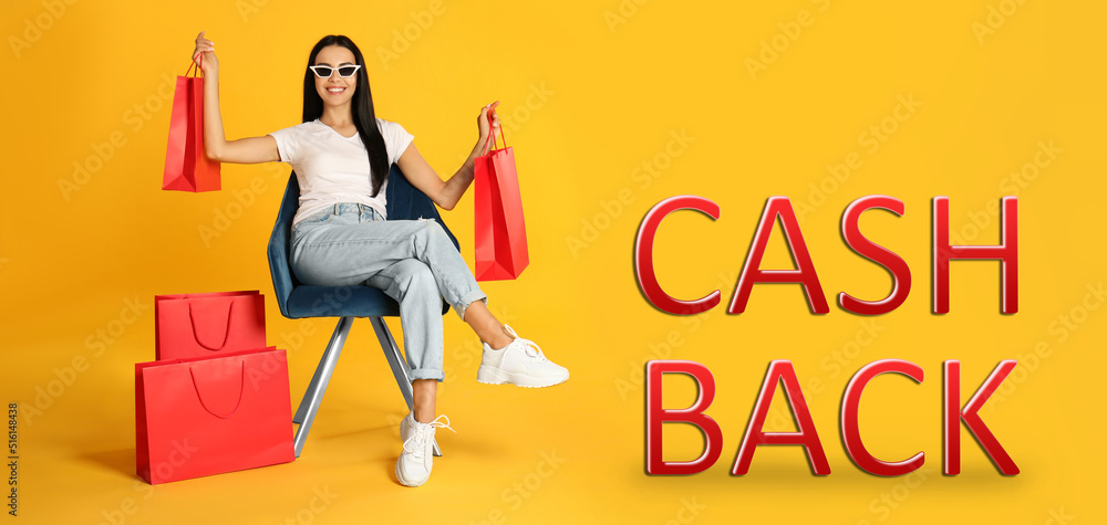 Beautiful woman with paper shopping bags in armchair and words Cash Back on yellow background. Banner design Beautiful woman with paper shopping bags in armchair and words Cash Back on yellow background. Banner design