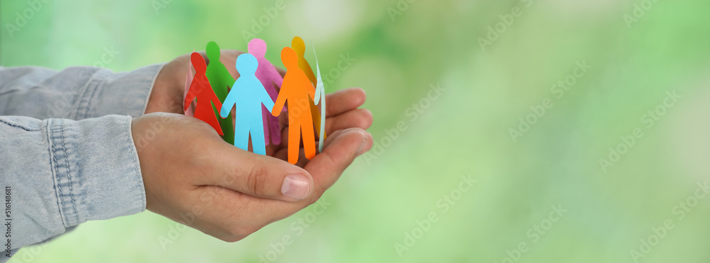 Woman holding paper human figures on blurred green background, closeup view with space for text. Diversity and Inclusion concept - obrazy, fototapety, plakaty 