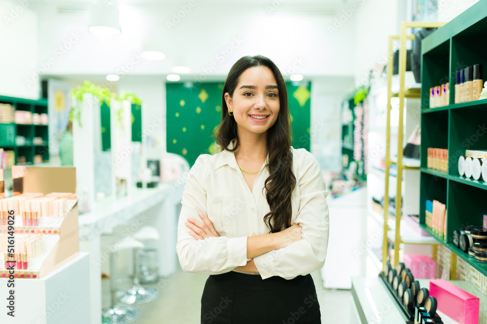Young latin woman working at the makeup shop