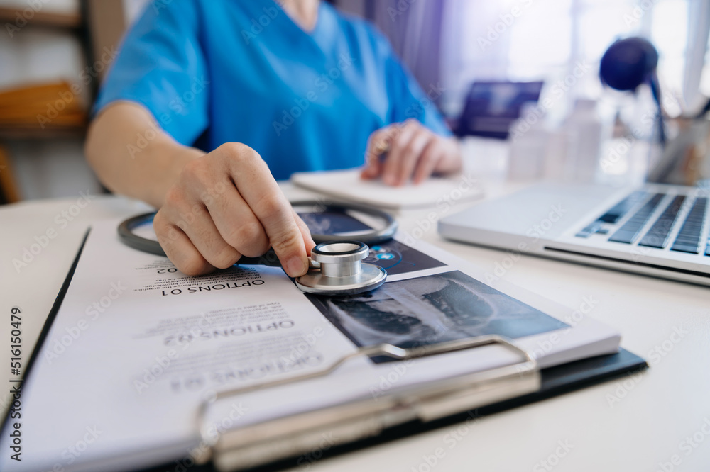 Medicine doctor and stethoscope using tablet with medical network connection and growth chart on laptop background. Medicine doctor and stethoscope using tablet with medical network connection and growth chart on laptop background.
