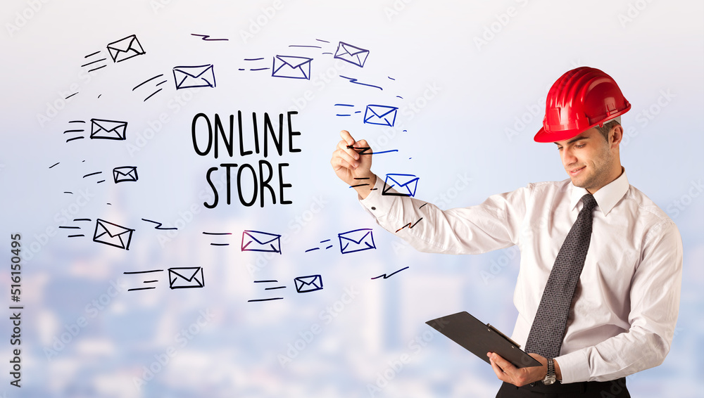 Young businessman with helmet drawing sale sign Young businessman with helmet drawing sale sign