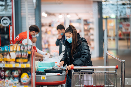 Young woman buying goods in a supermarket