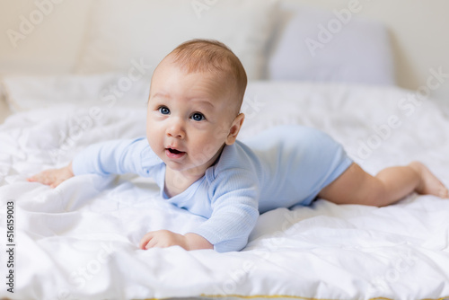 cute little boy in blue body laying on blanket, card, banner, health, space for text