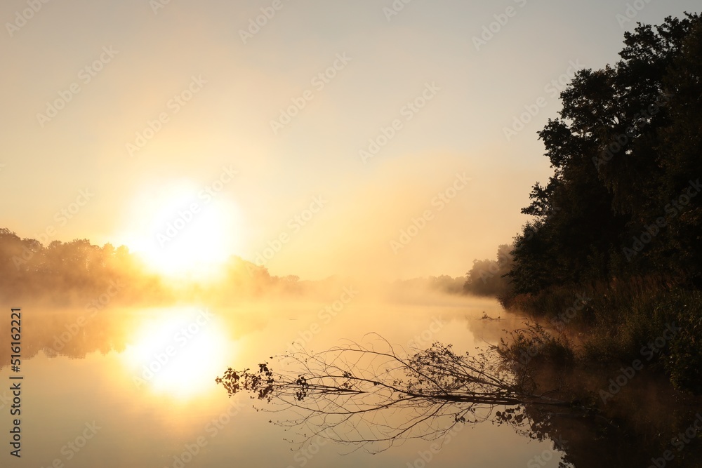 Sunrise over a lake on a foggy spring day Sunrise over a lake on a foggy spring day