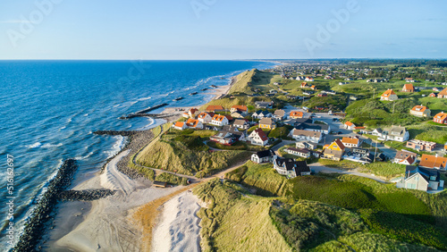 Aerial view of the scenic coast line of Denmark with the idyllic village of Lonstrup sitting on the dunes and rocks photo