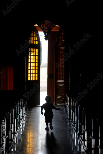 Child running in the basilica di Santa Maria della Coltura, Parabita, Apulia photo