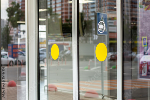 Supermarket automatic glass doors with camera sign closeup