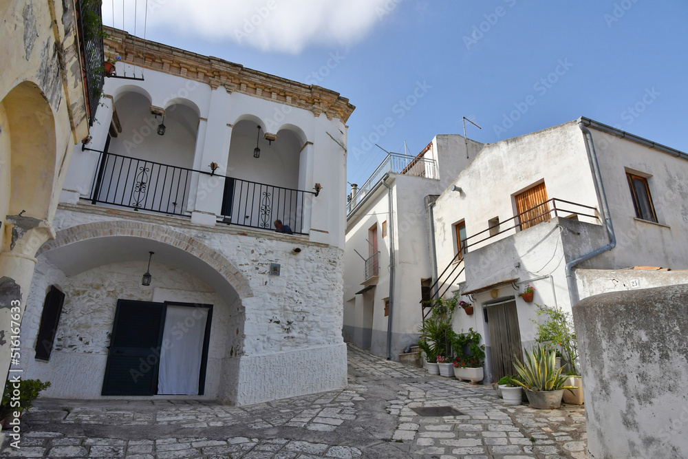 A narrow street between the old houses of Grottole, a village in the Basilicata region, Italy.