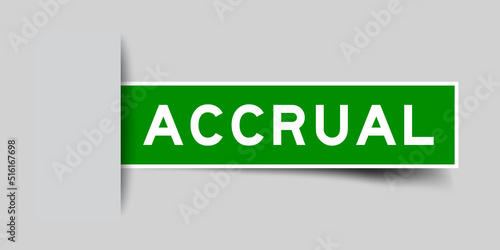 Inserted green color label sticker with word accrual on gray background