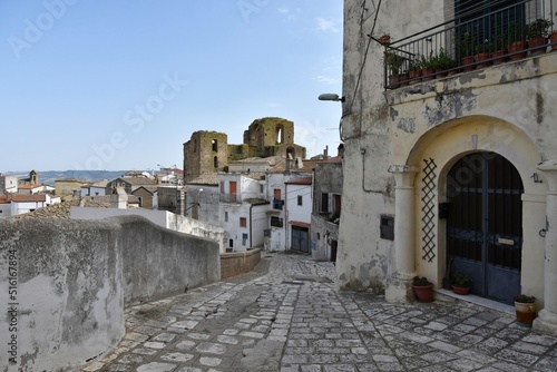 A narrow street between the old houses of Grottole, a village in the Basilicata region, Italy. © Giambattista