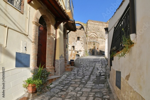 A narrow street between the old houses of Grottole  a village in the Basilicata region  Italy.