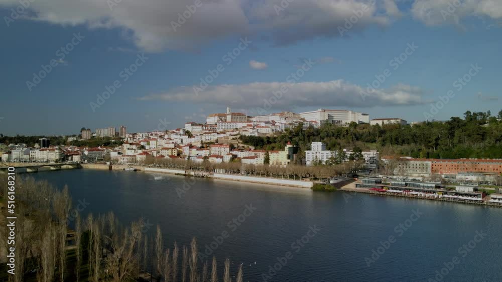 Aerial view of the city of Coimbra from the river side with th view of the university. Cinematic drone shot inn 4K Aerial view of the city of Coimbra from the river side with th view of the university. Cinematic drone shot inn 4K