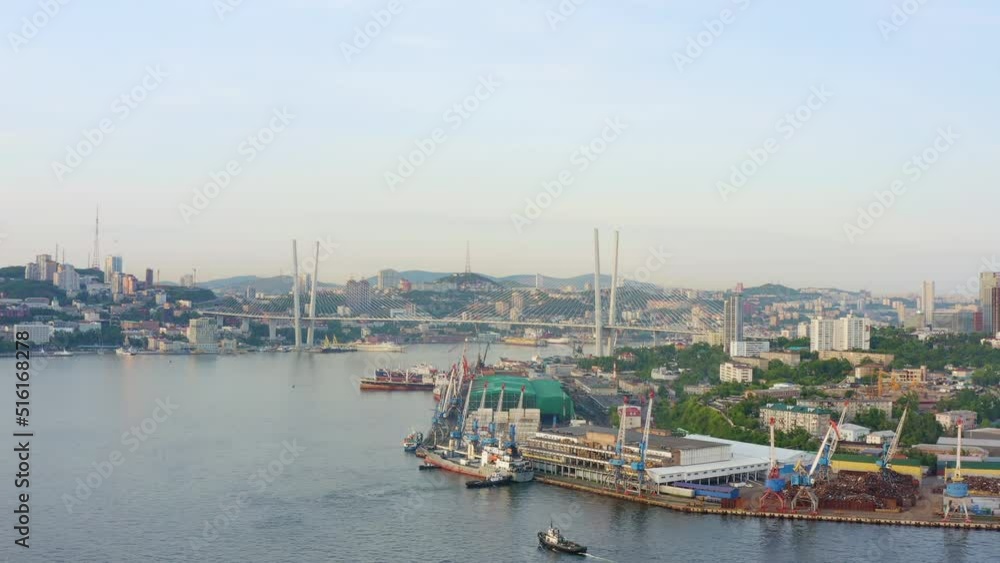 View of the cityscape of Vladivostok. The famous modern Golden Bridge across the sea bay. Panoramic view. Drone cinematic movement. Tourist attraction of the Far Eastern capital of Russia View of the cityscape of Vladivostok. The famous modern Golden Bridge across the sea bay. Panoramic view. Drone cinematic movement. Tourist attraction of the Far Eastern capital of Russia