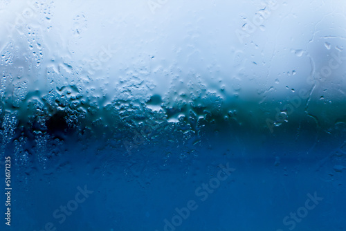 Wet, after the rain, the glass in the window of the house