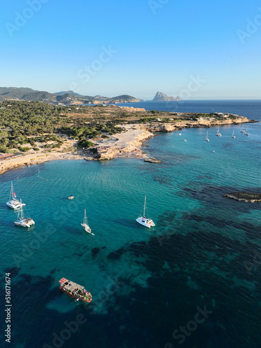 Cala Comte beach in Ibiza. The island of Es Vedra can be seen in the background.