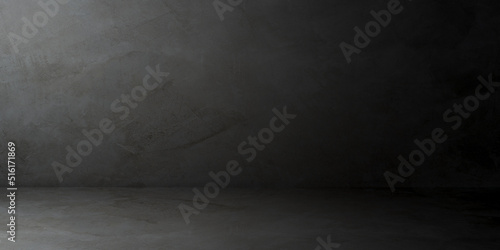 Empty dark gray cement wall room interiors studio backgrounds and rough floor with soft light well editing montage display products and text present on free space concrete backdrop