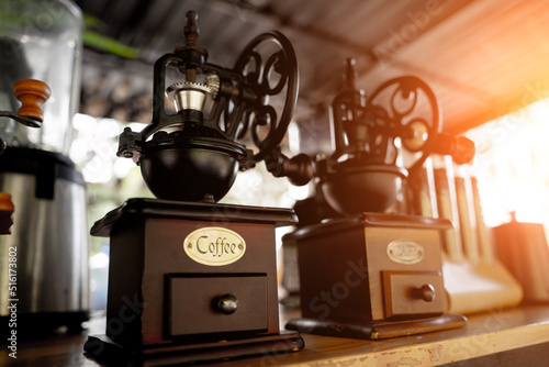 Old coffee grinder and coffee on cafe background