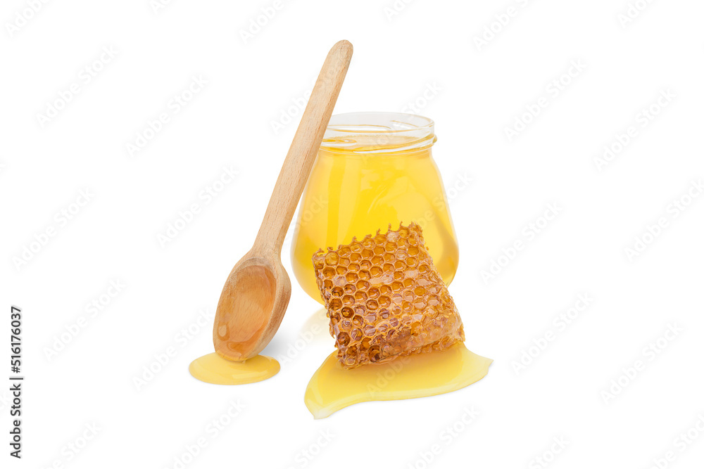 isolated jar with honey next to a wooden spoon and a piece of beeswax with honey isolated jar with honey next to a wooden spoon and a piece of beeswax with honey