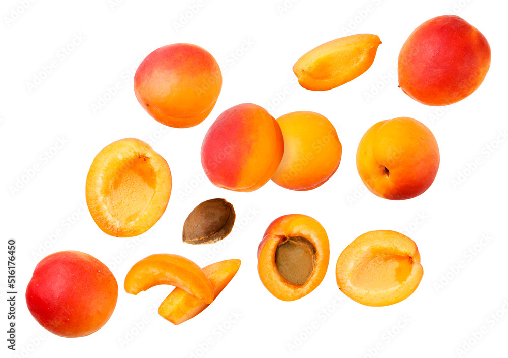 Set of ripe apricots and pieces are flying on a white background. Isolated Set of ripe apricots and pieces are flying on a white background. Isolated