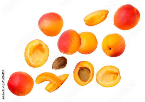 Set of ripe apricots and pieces are flying on a white background. Isolated