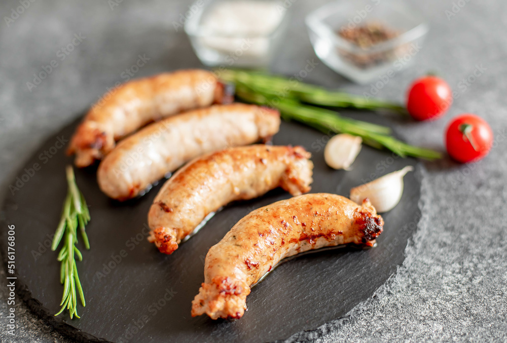 grilled sausages from turkey meat with spices on a stone background 