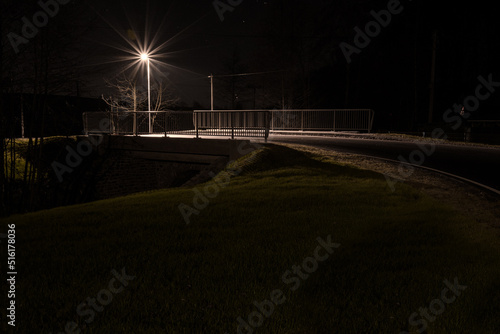 A small bridge and a lamp at night