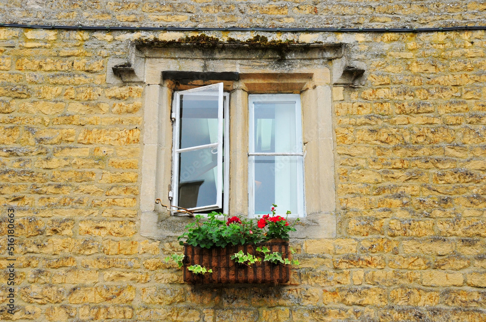 Photo of a window on a brick wall
