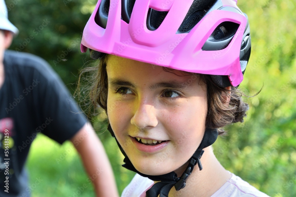 Head portrait of laughing girl wearing protective helmet while cycling Head portrait of laughing girl wearing protective helmet while cycling