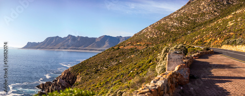 Fotografie Panoramic view of the cliff of the fynbos coast in South Africa, known as the garden road and clarence drive with the Atlantic ocean in the background in the gordon bay's area in South Africa