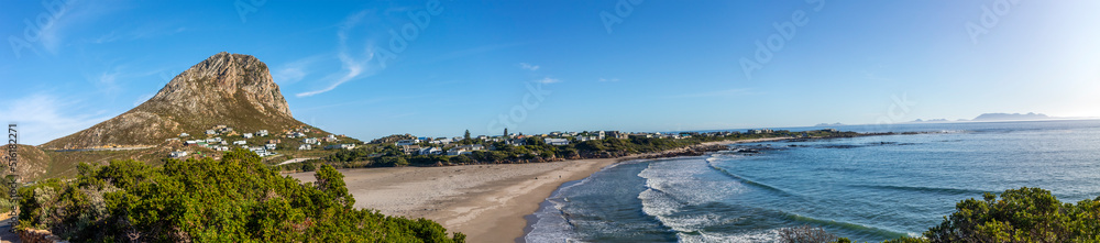 Panoramic view of Gordon Bay's mountain scenery on the coastline of the Fynbos coast in South Africa known as the Garden Route, the southernmost route through Africa. Panoramic view of Gordon Bay's mountain scenery on the coastline of the Fynbos coast in South Africa known as the Garden Route, the southernmost route through Africa.